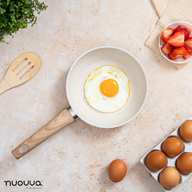 Cream frying pan with wooden handle.